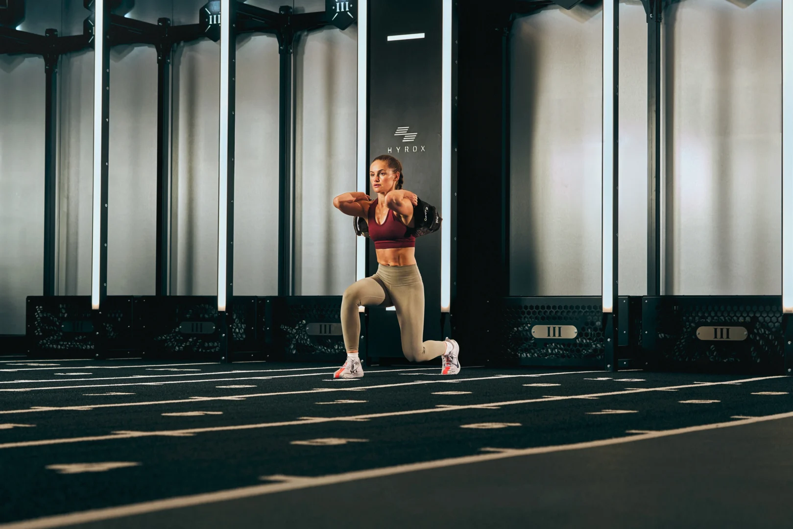Athlete performing lunges at a Hyrox gym